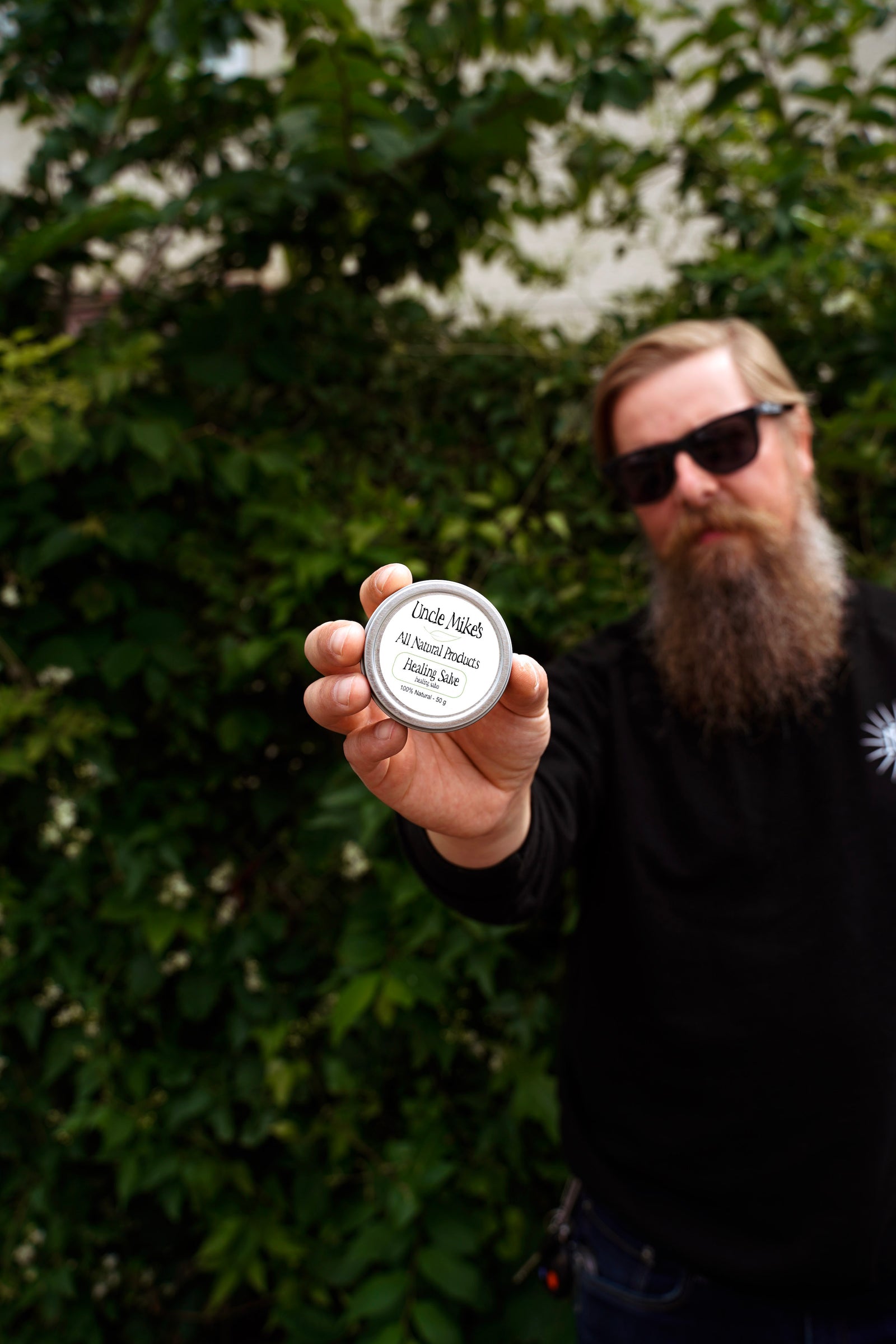 Uncle Mike holding a container of his all natural Healing Salve